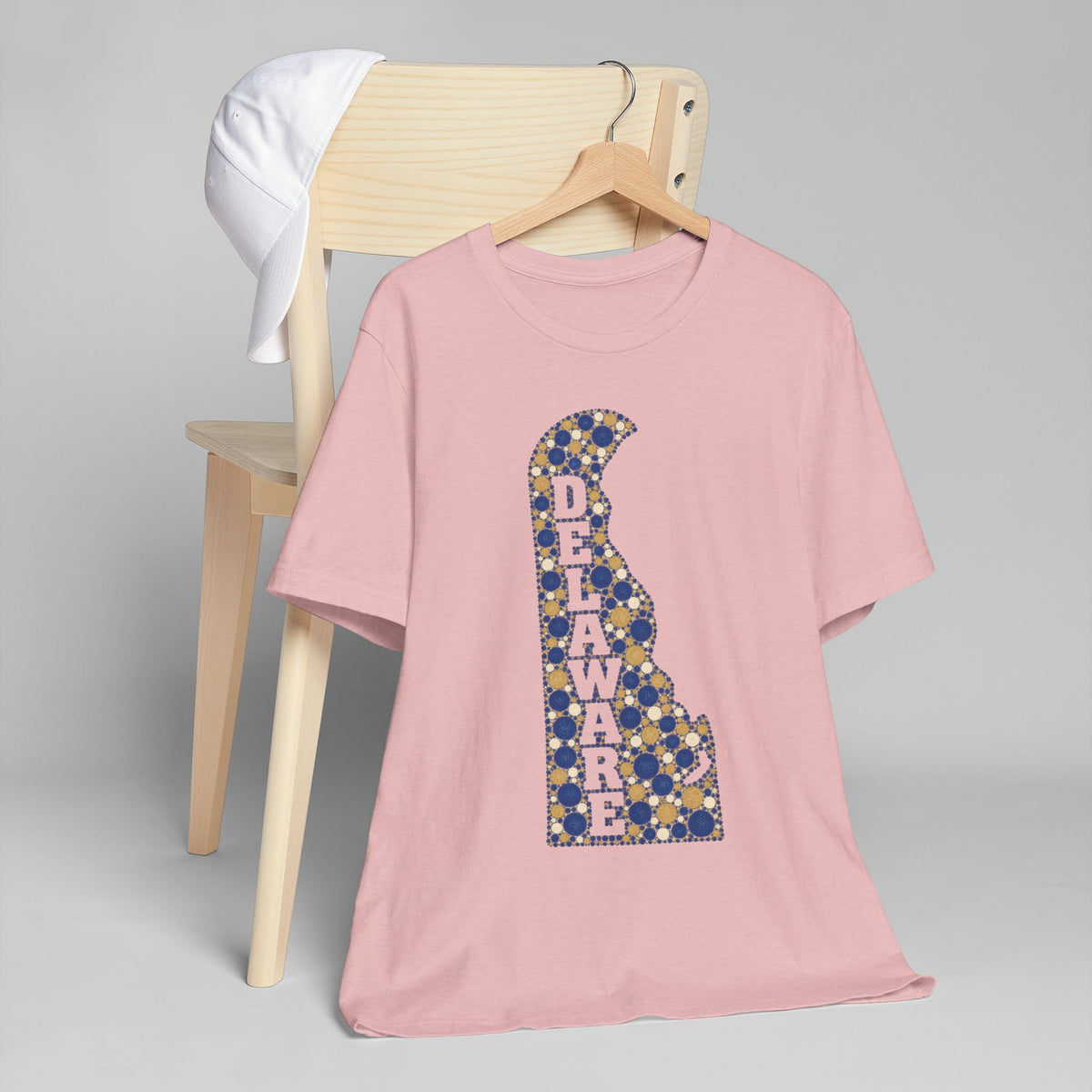 Pink T-shirt with blue-and-gold Delaware map alphabet graphic on front