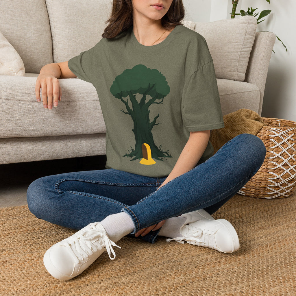 Olive green T-shirt with tree and yellow door graphic, worn with jeans and white sneakers.