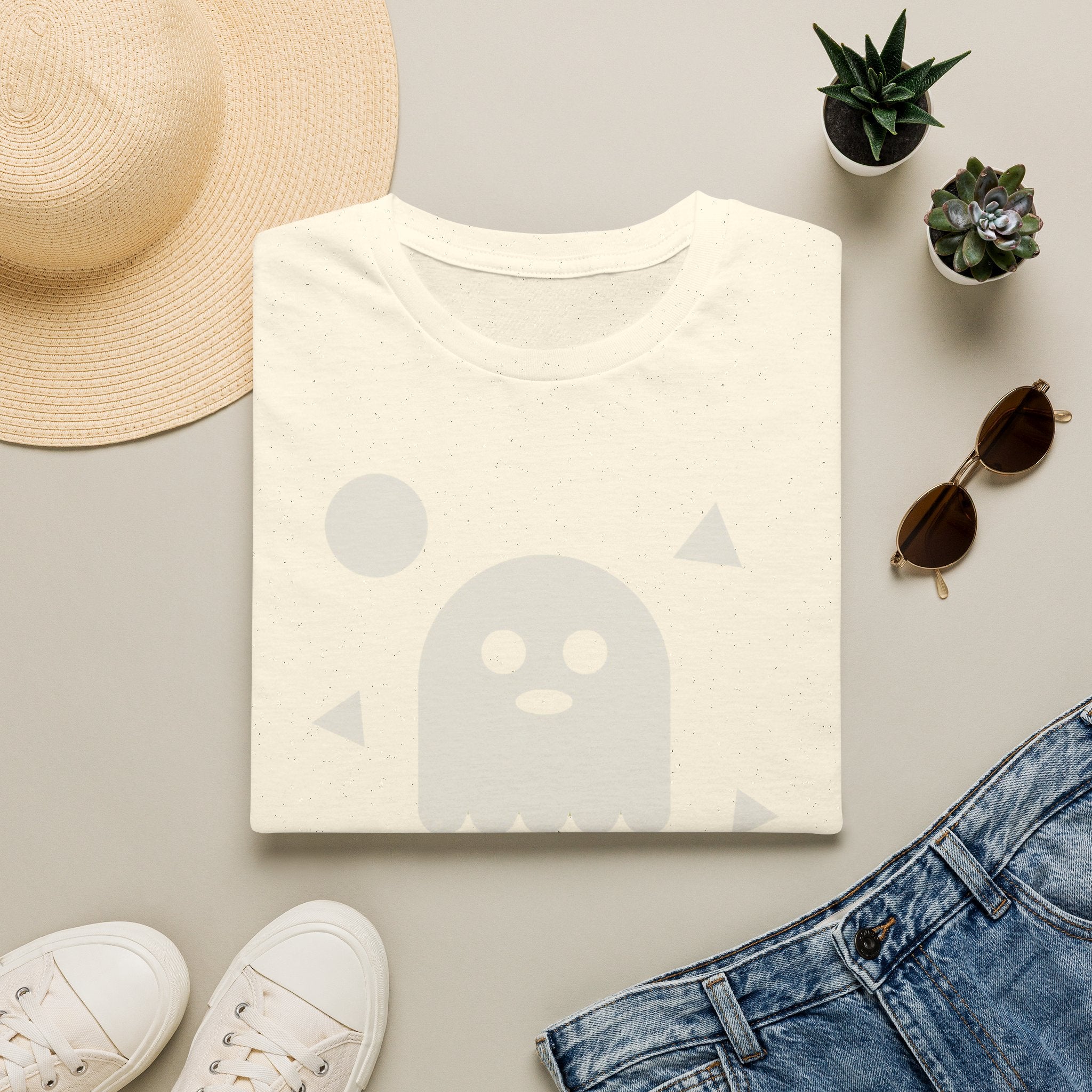 Cream T-shirt with light ghost face graphic and small triangle accents on front