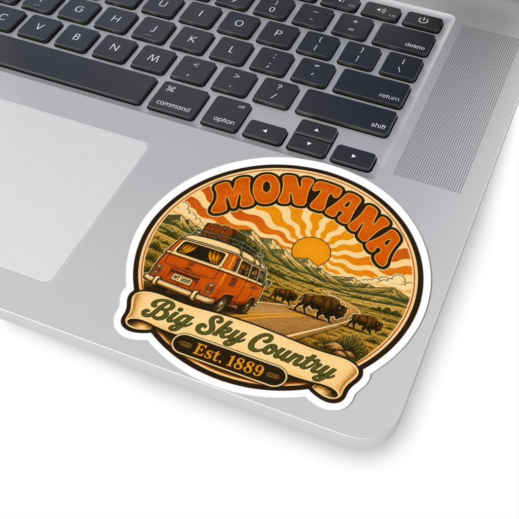 Round Montana sticker with retro orange camper, buffalo herd, and 'Big Sky Country' lettering
