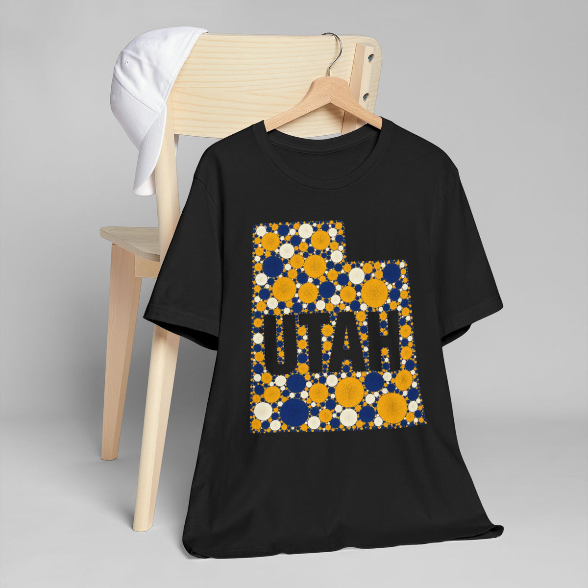 Black short-sleeve T-shirt with “UTAH” polka dot map graphic in blue and gold