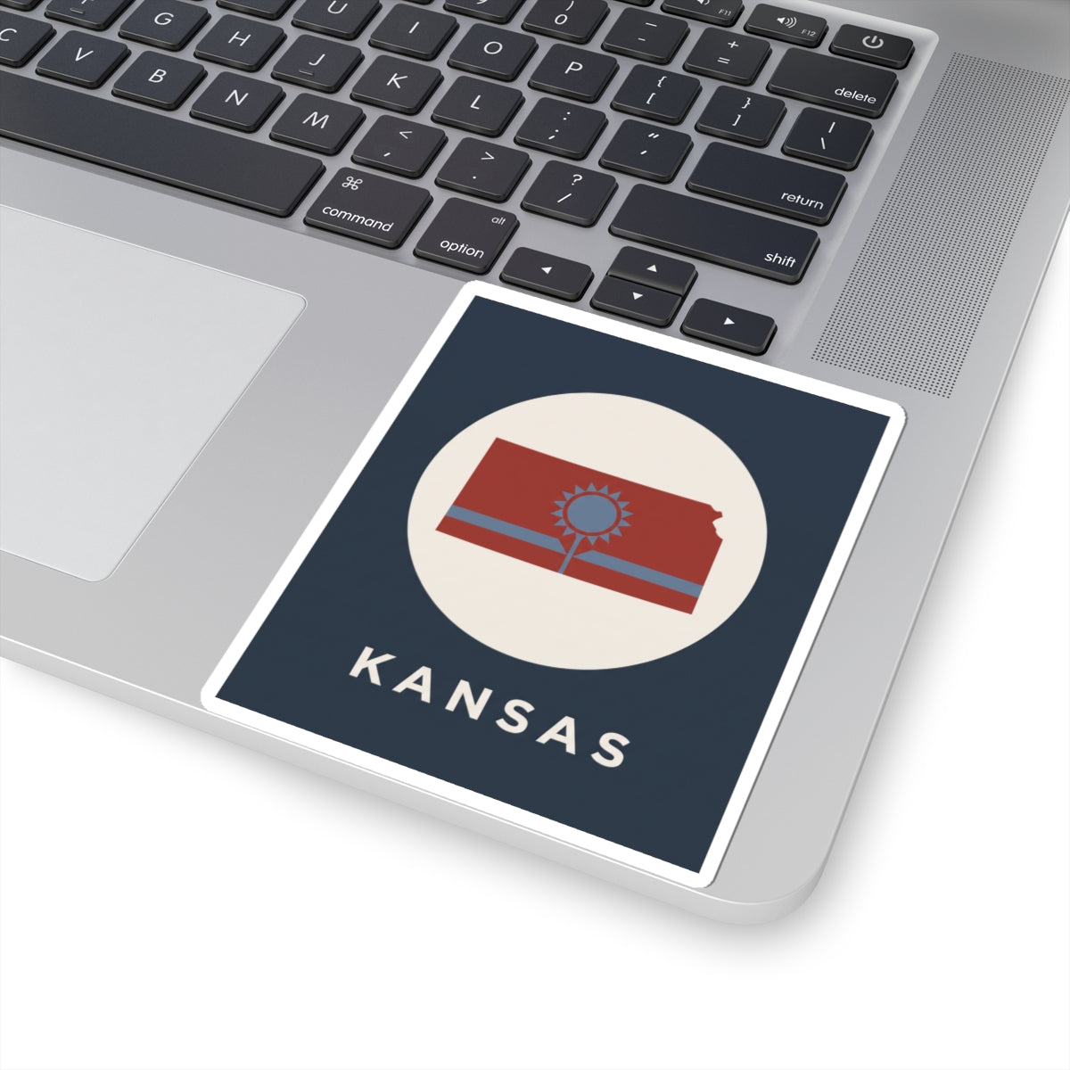 Angled rectangular Kansas sunflower state sticker, blue background, “KANSAS” text