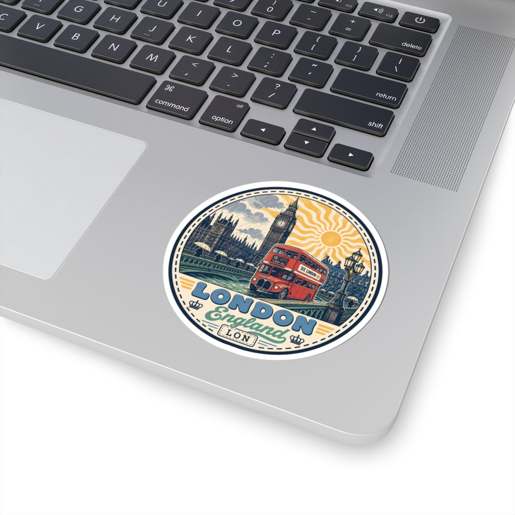 Round London sticker on light device surface: red double-decker bus, Big Ben, sun