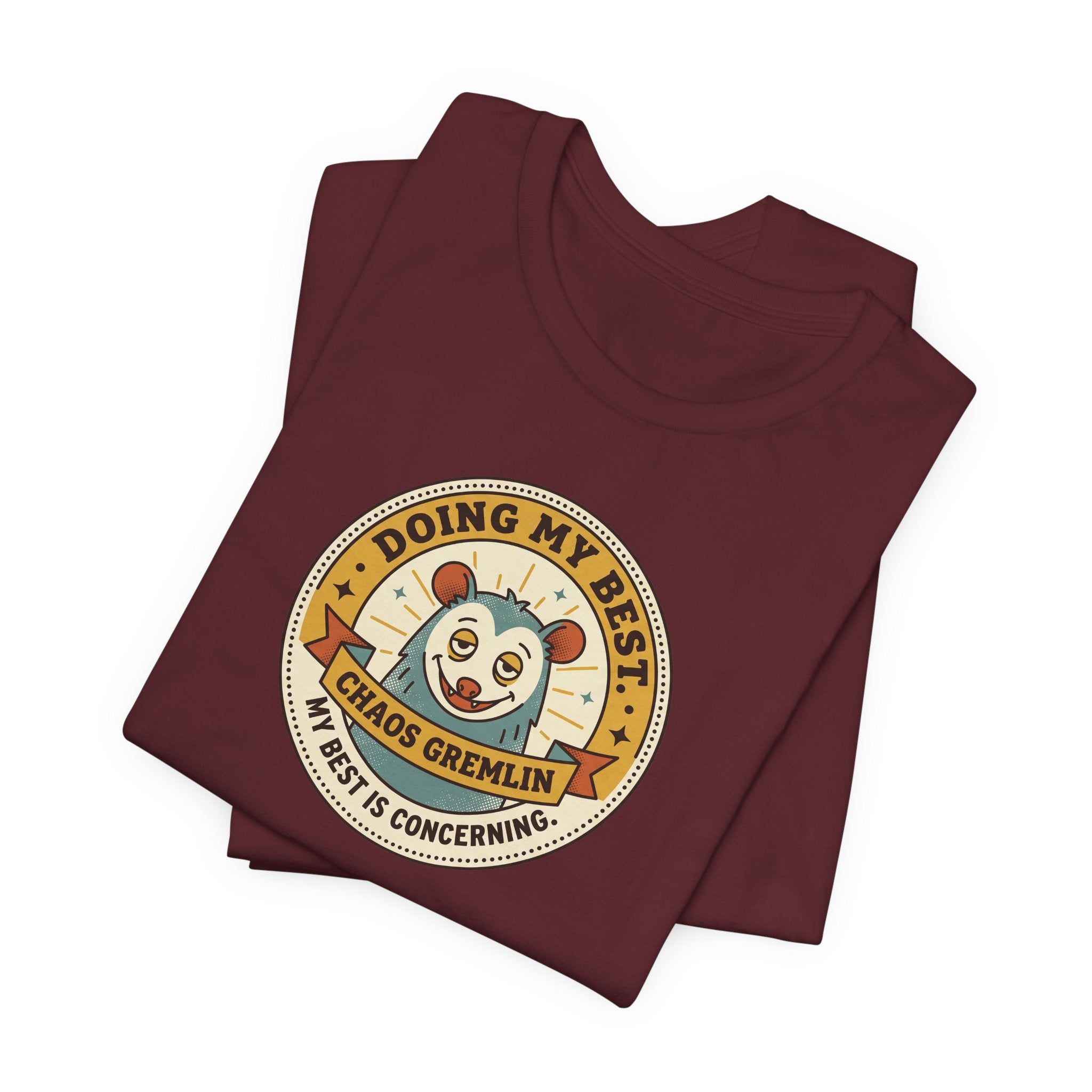 Maroon T-shirt with circular gremlin badge graphic, short sleeves, crew neck.
