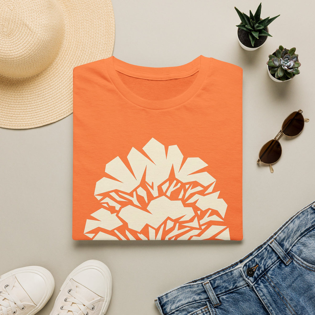 Orange t-shirt with geometric faceted tree silhouette graphic on front.