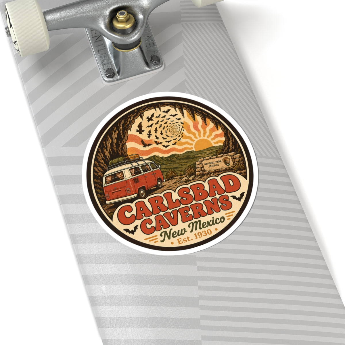 Round Carlsbad Caverns sticker on a gray striped notebook cover, featuring orange camper van art