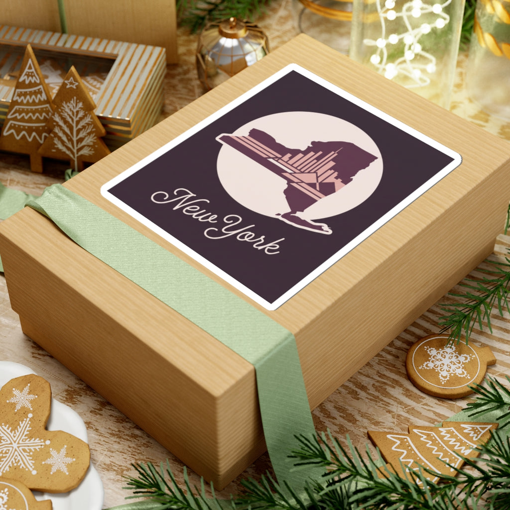 New York skyline decal sticker on a wrapped gift box, with circular emblem and cursive “New York”.