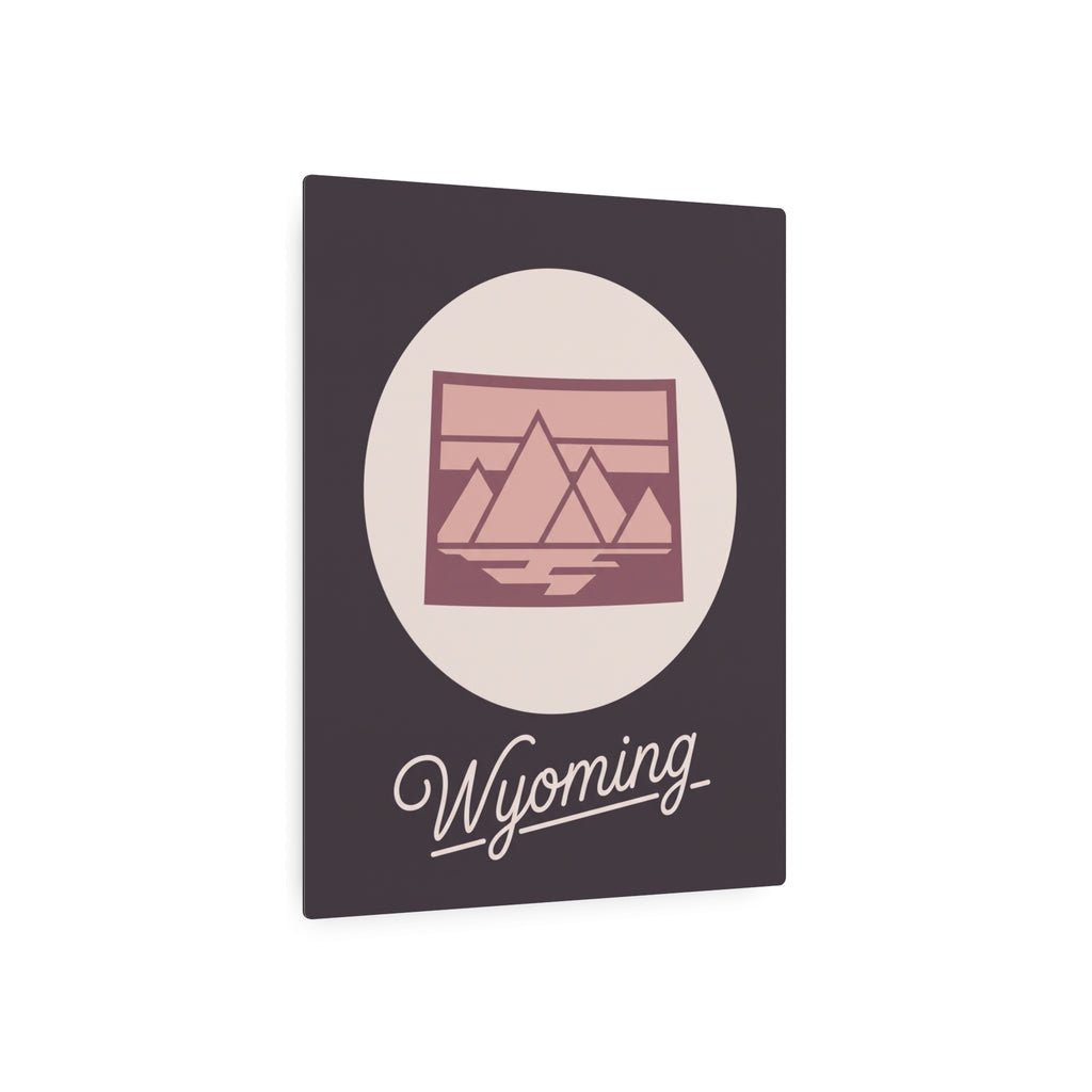 Square mauve metal wall art displaying oval landscape emblem and cursive “Wyoming”