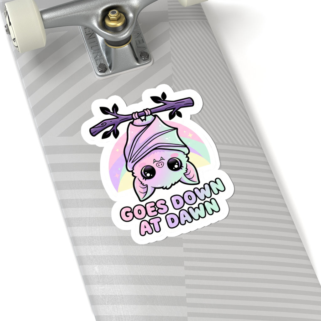 Kawaii kiss-cut vinyl sticker featuring purple bat, pink hood, and "GOES DOWN AT DAWN" text