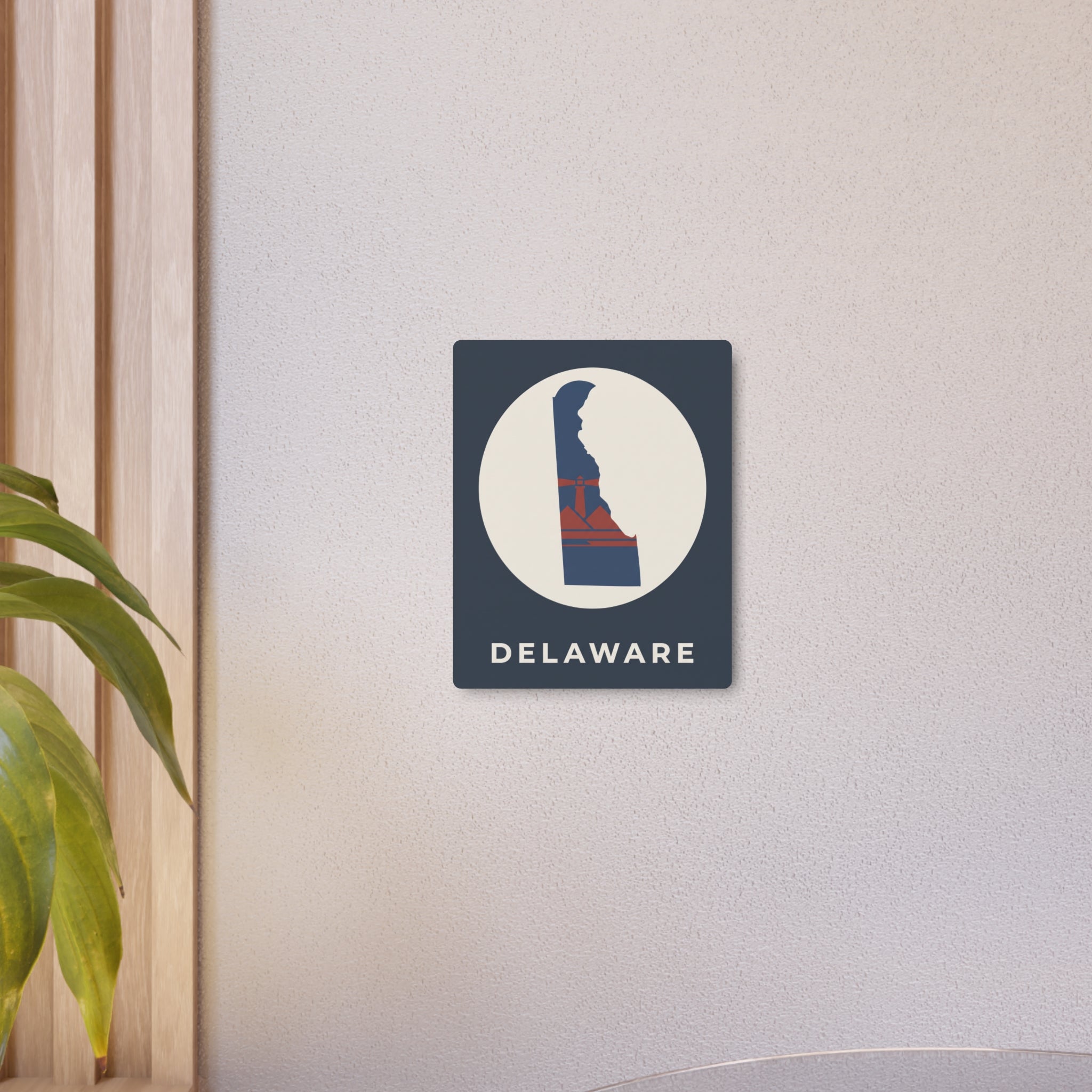 Delaware metal state map art sign mounted on wall, dark blue square with circle emblem