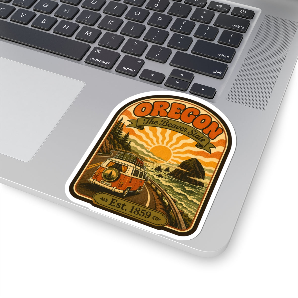 Oregon The Beaver State sticker on a laptop, showing retro van, waves, and Est. 1859