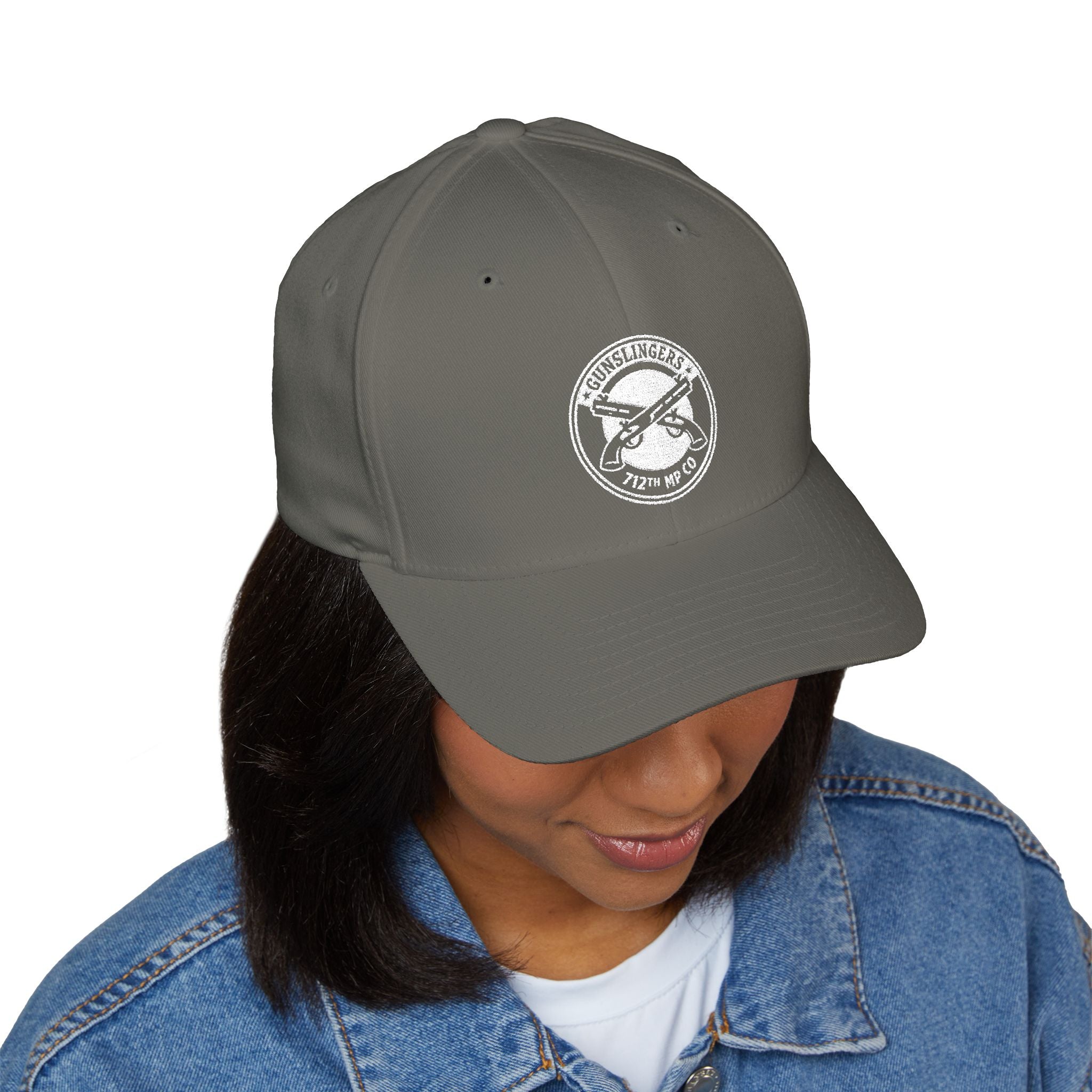 Dark grey baseball cap with white circular embroidered badge