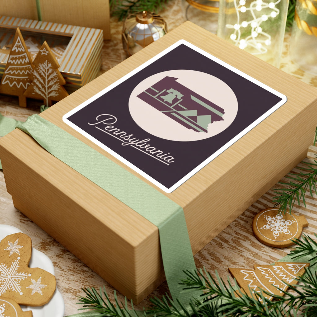 Pennsylvania state silhouette sticker on wrapped gift box, purple and green with “Pennsylvania” script