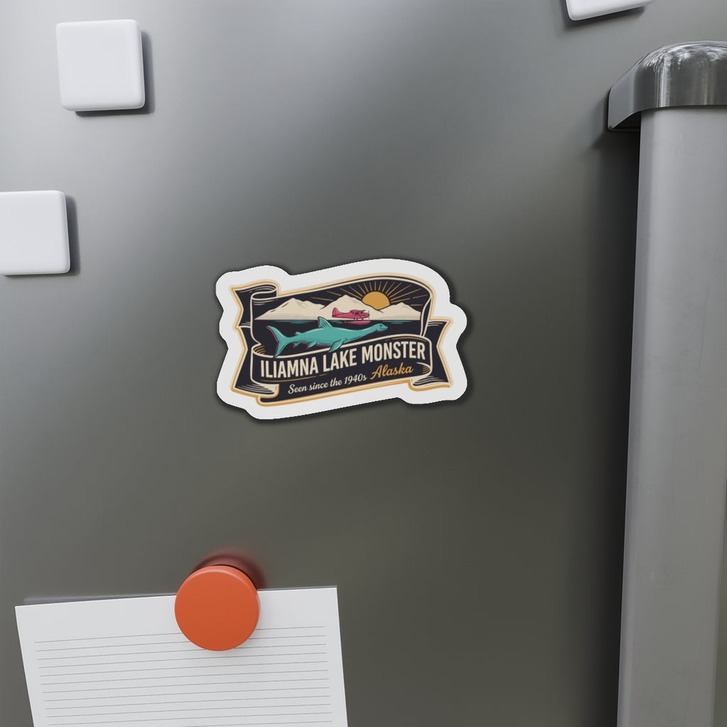 Die-cut lake monster decal magnet on stainless refrigerator door with a paper note