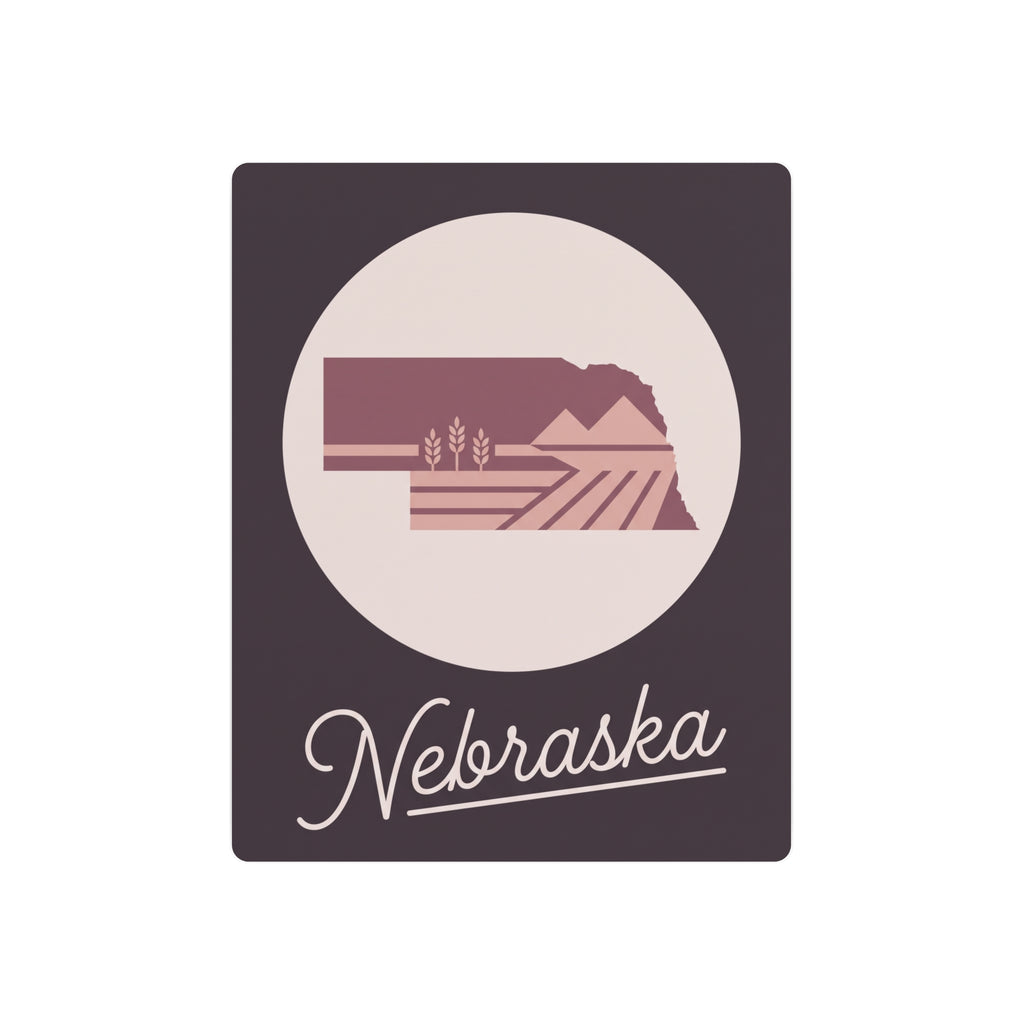 Mauve Nebraska metal wall art with oval landscape silhouette and 'Nebraska' script