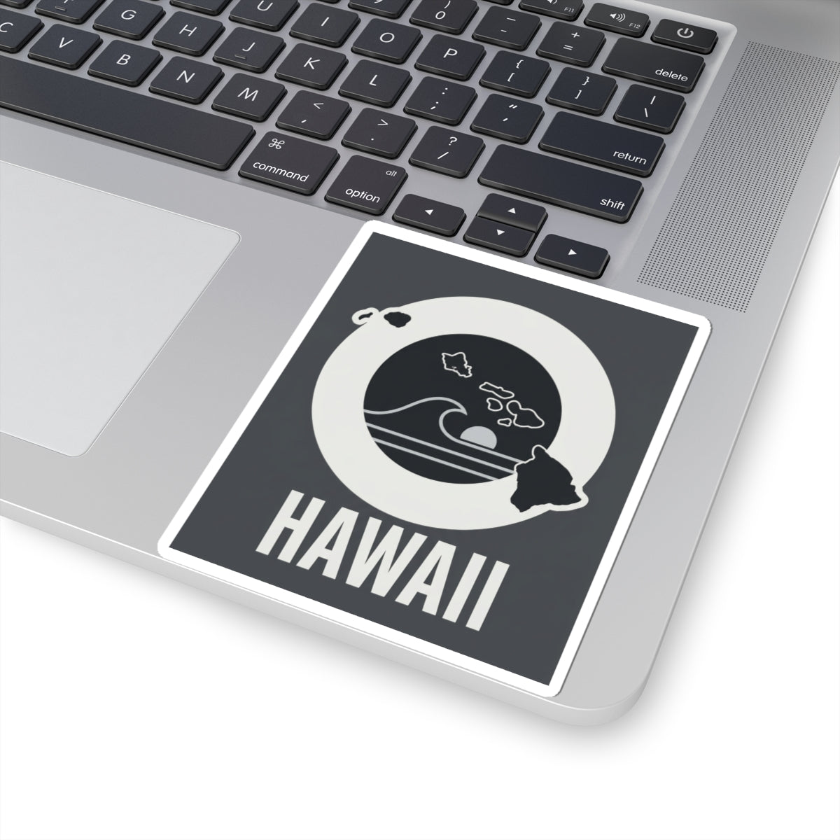 Square kiss-cut sticker on laptop, white-bordered design with HAWAII text and wave emblem