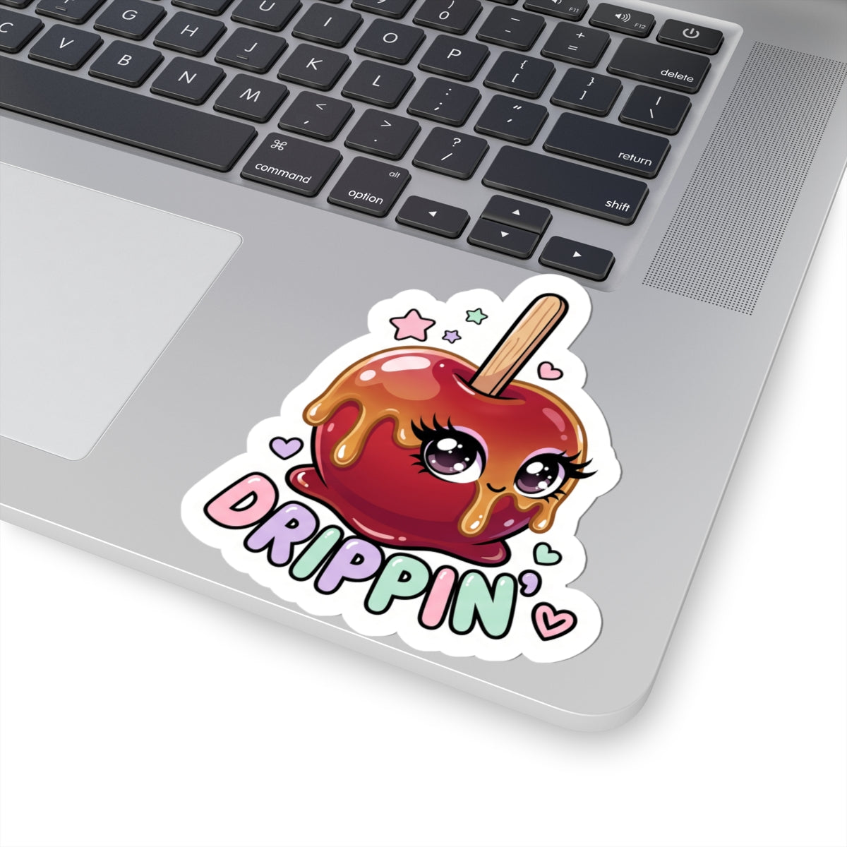 Kiss-cut sticker featuring a red candy apple face with "DRIPPIN'" on a laptop lid