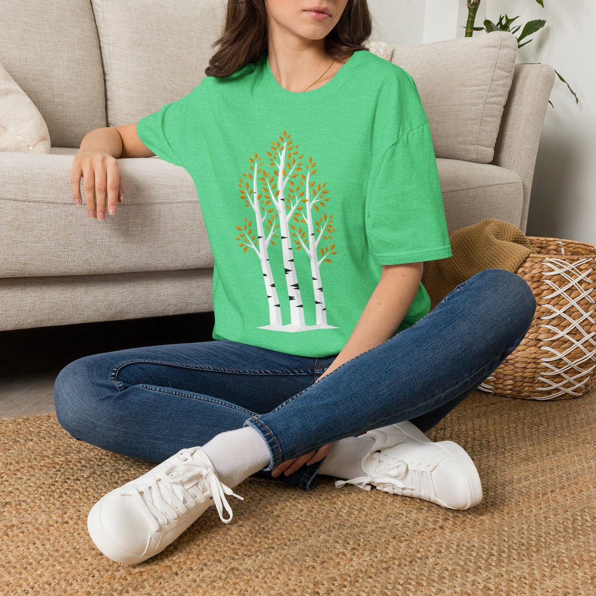 Bright green T-shirt with birch tree autumn leaves graphic on the front.