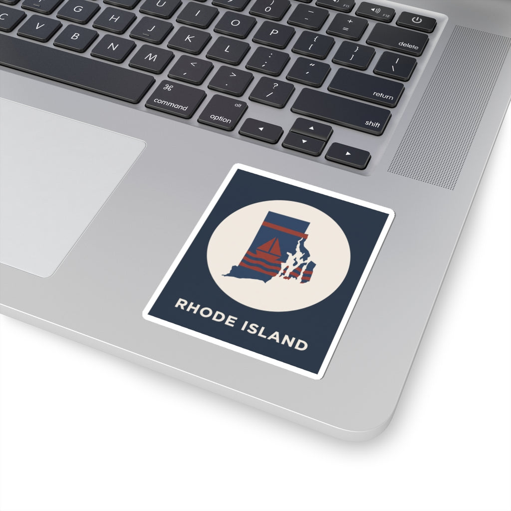 Rhode Island nautical map sticker on a laptop keyboard, blue rectangle with circular sailboat