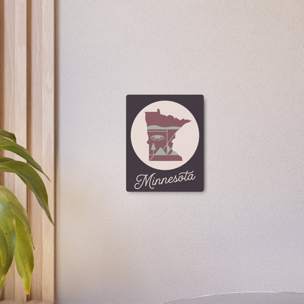 Small Minnesota metal wall art sign on wall with dark square, circular silhouette, pink-and-sage “Minnesota” script.