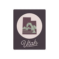 Dark square metal wall plaque with circular Utah silhouette and “Utah” script