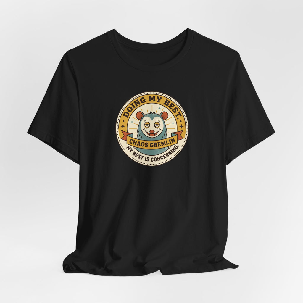 Black crewneck T-shirt with round cartoon gremlin badge graphic on chest