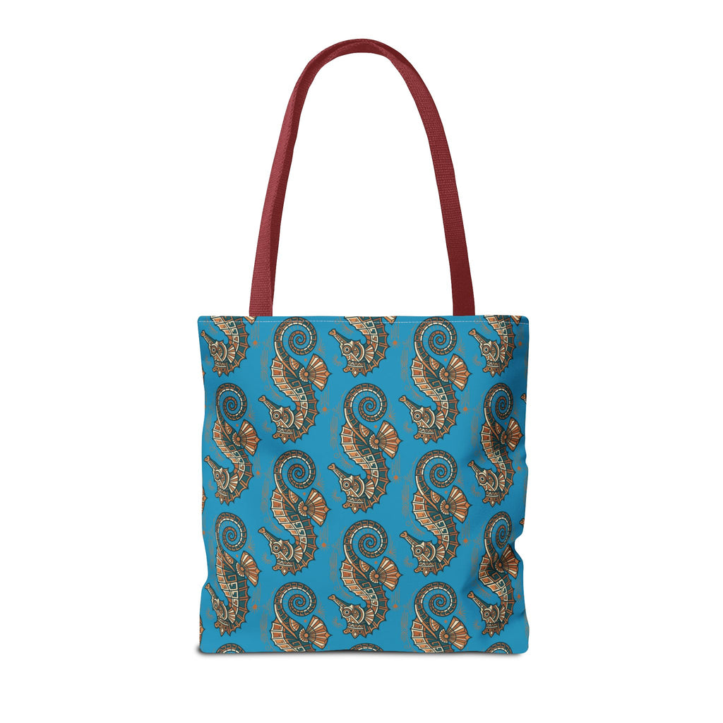 Tote bag front view in blue with seahorse pattern and red handles
