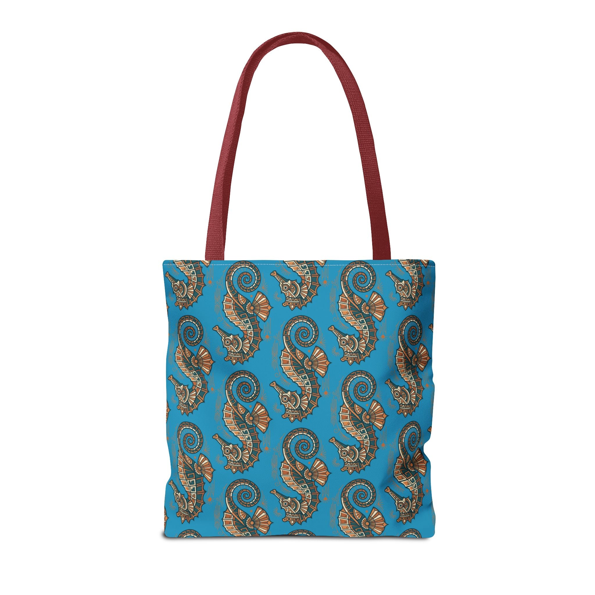 Tote bag front view in blue with seahorse pattern and red handles
