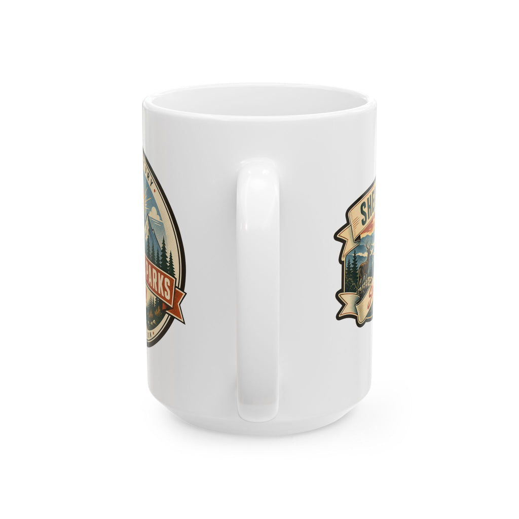 White ceramic mug with two landscape badge decals and molded side handle.
