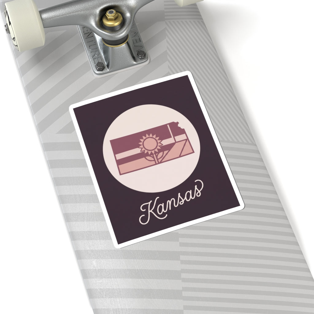 Kansas state silhouette mauve vinyl sticker decal with sunburst design and “Kansas” lettering
