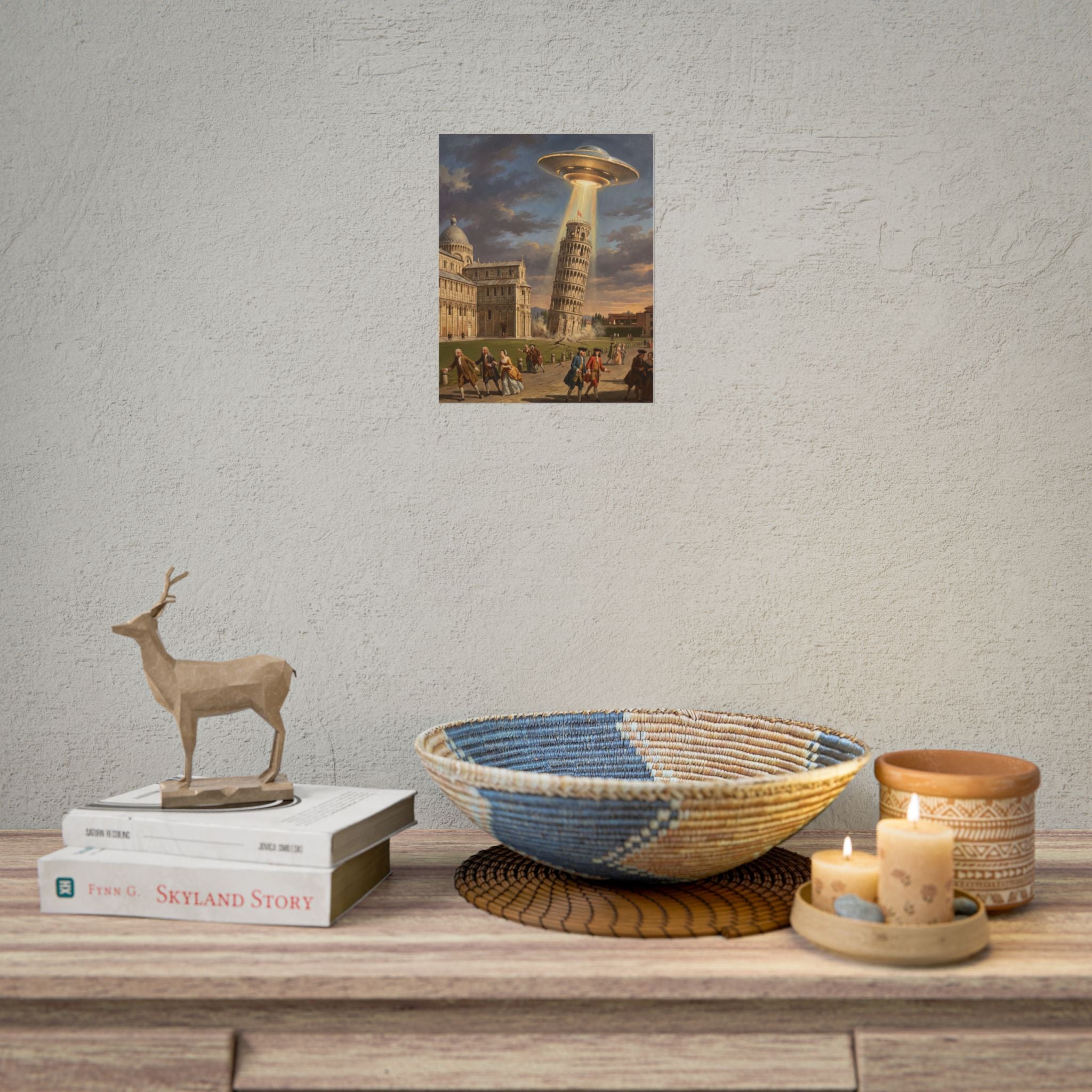 Small framed poster on wall featuring UFO above Leaning Tower and crowd in a vintage street
