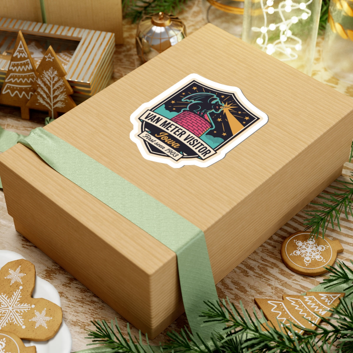 Visitor badge kiss-cut sticker on gift wrap, featuring Iowa script and red brick