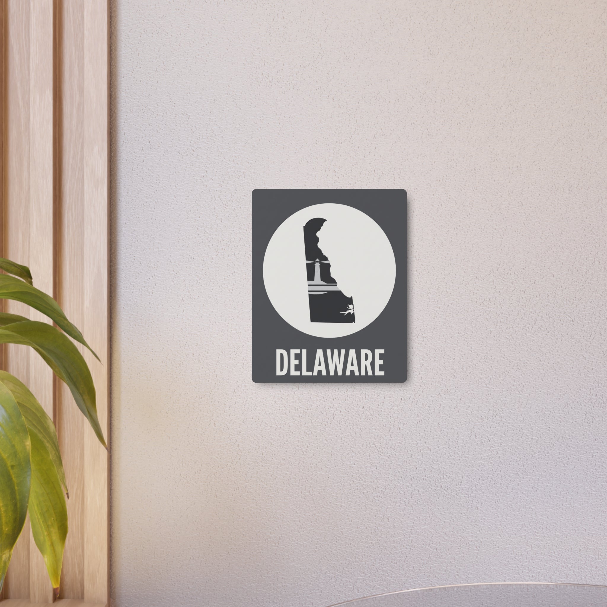 Delaware lighthouse silhouette metal wall sign with circular badge and bold “DELAWARE” lettering