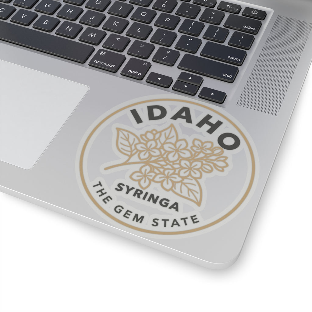 Transparent vinyl sticker on laptop: Idaho syringa floral emblem with "the gem state"