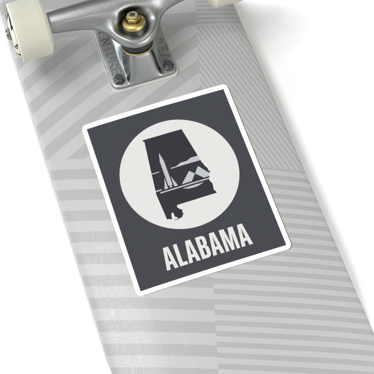 Alabama outline vinyl decal sticker with white circle emblem and “ALABAMA” text on light striped surface