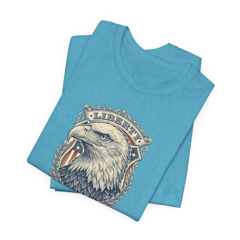 Teal crewneck t-shirt with eagle head graphic and laurel emblem on front.