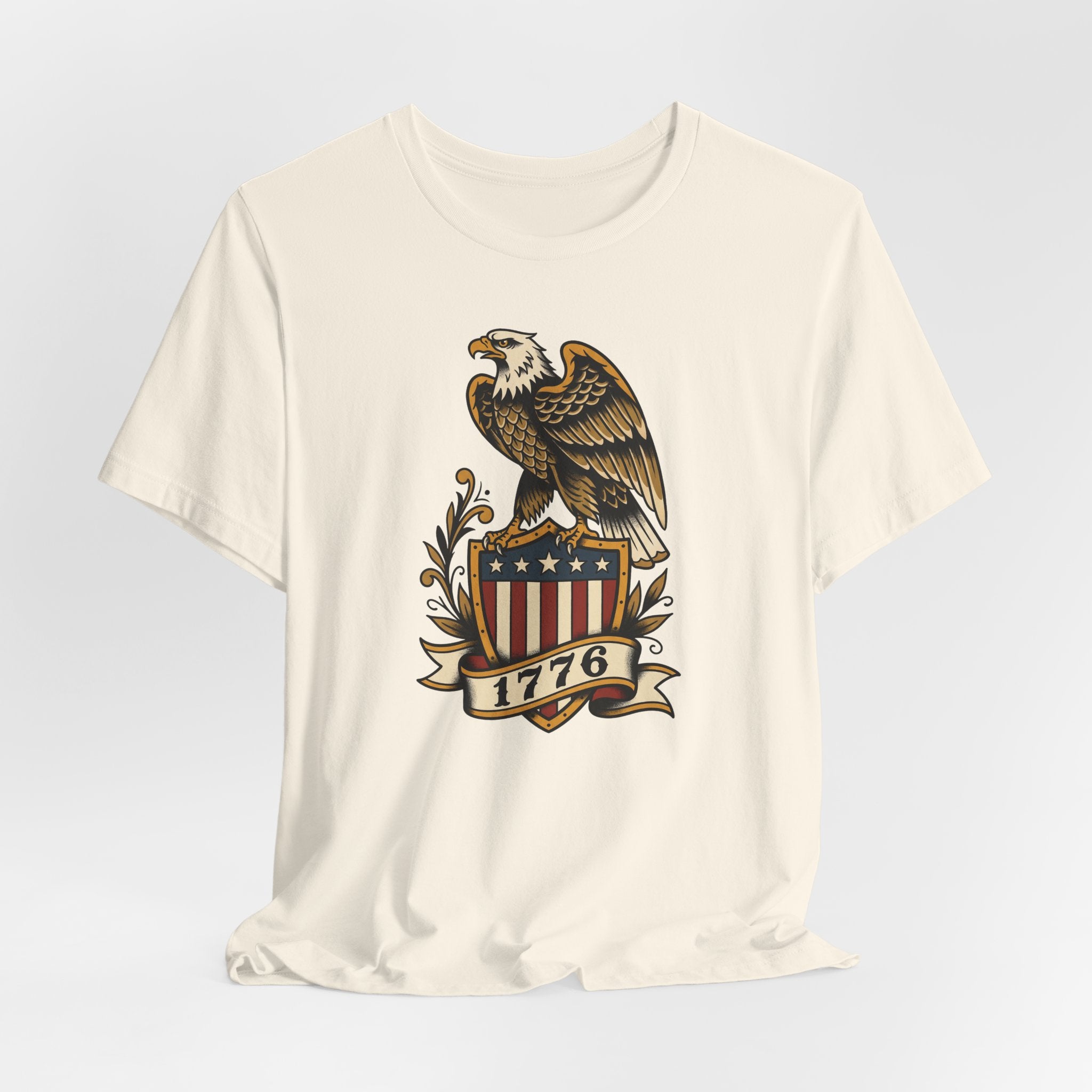 Cream crewneck T-shirt featuring bald eagle shield graphic with stars and 1776 banner