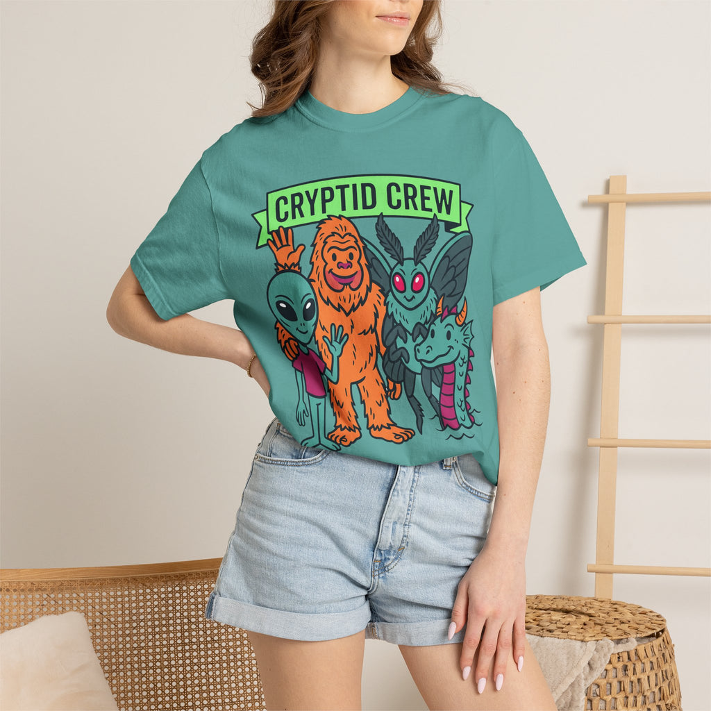 Teal crew-neck T-shirt with 'CRYPTID CREW' graphic, worn by model.