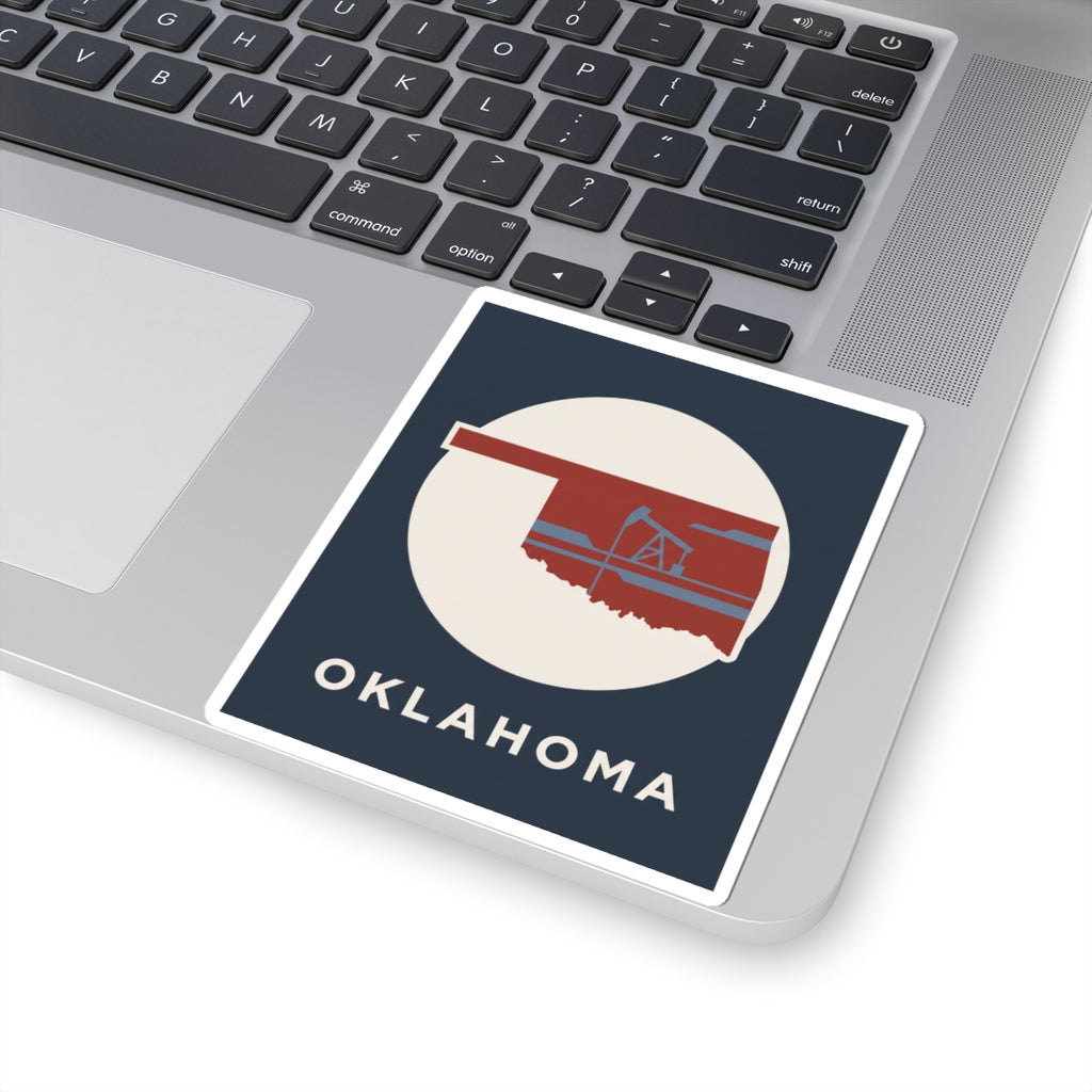 Kiss-cut vinyl Oklahoma sticker on laptop, oil rig graphic with OKLAHOMA text