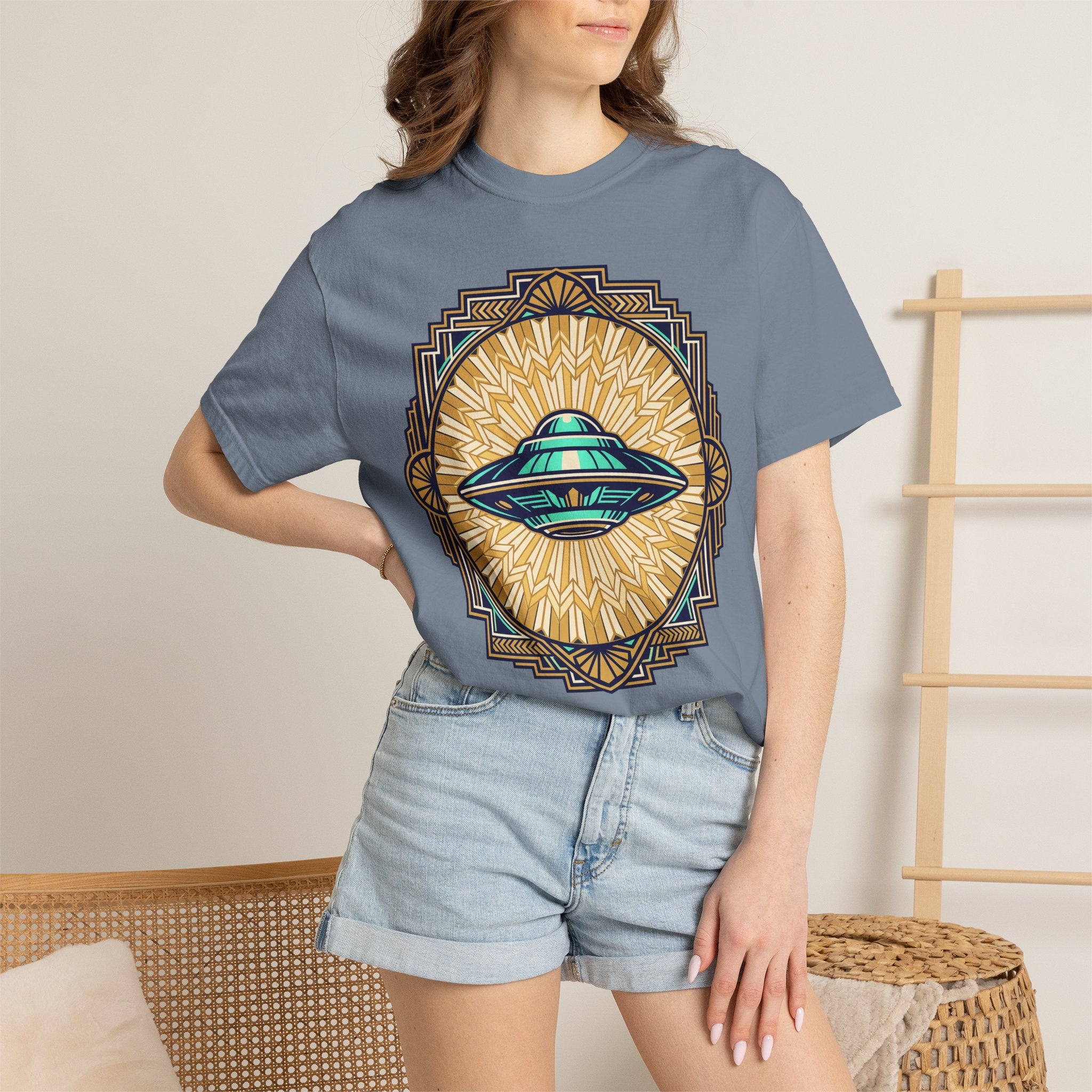 Blue T-shirt with retro UFO graphic and sunburst emblem, worn by model