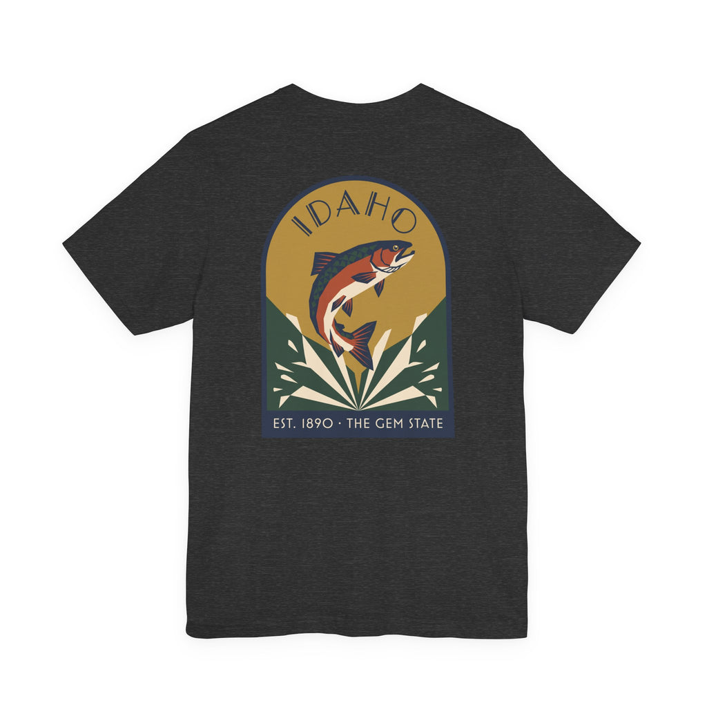 Dark charcoal crewneck t-shirt with circular Idaho trout badge graphic and "EST. 1890 • THE GEM STATE" text.