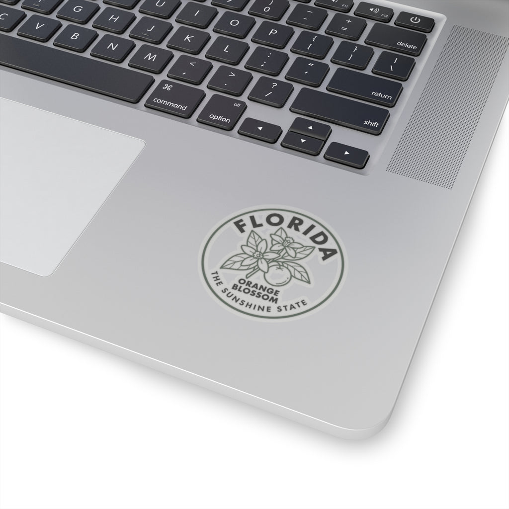 Transparent vinyl sticker on a laptop, Florida orange blossom circular emblem