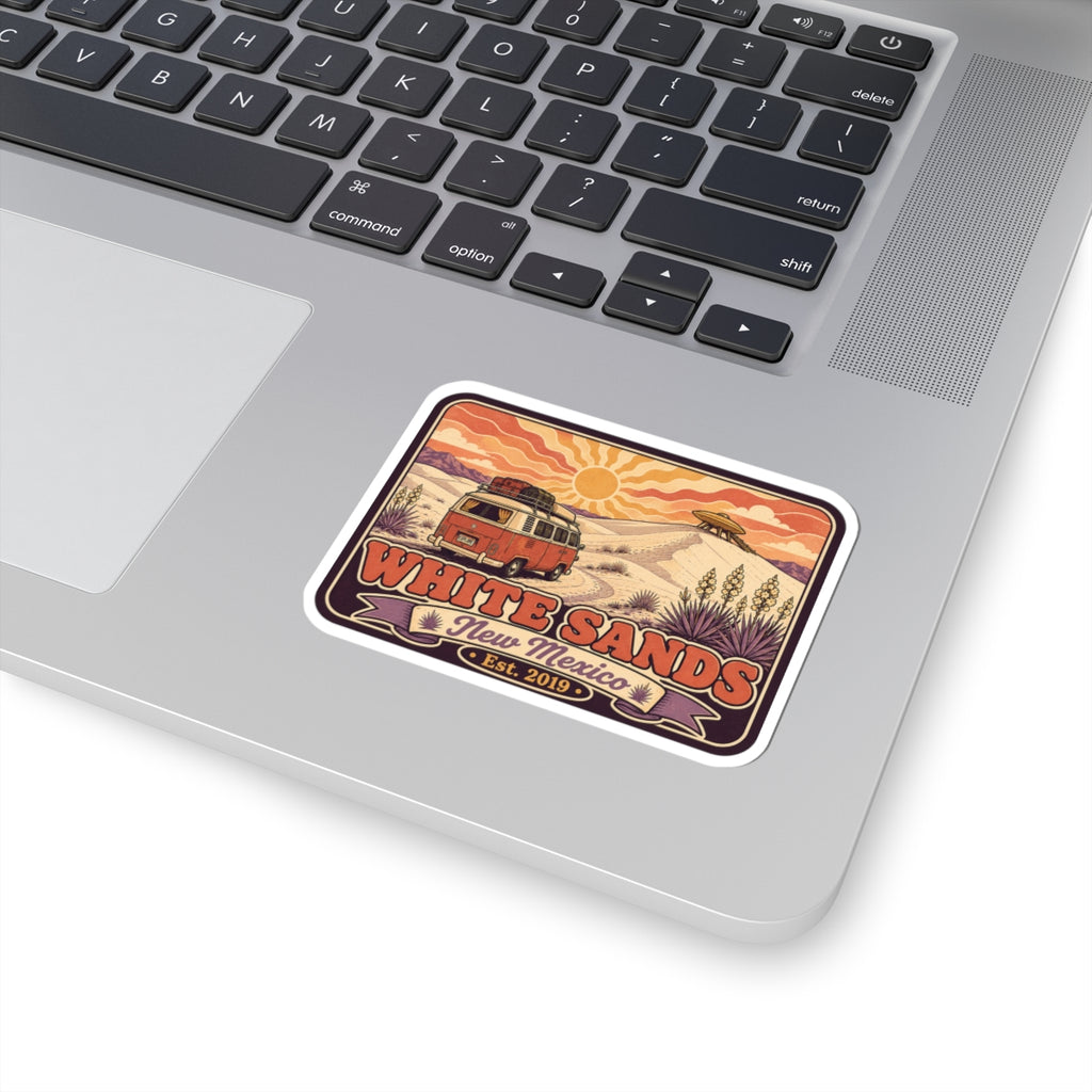 Vinyl sticker on light laptop surface; vintage camper desert graphic with White Sands