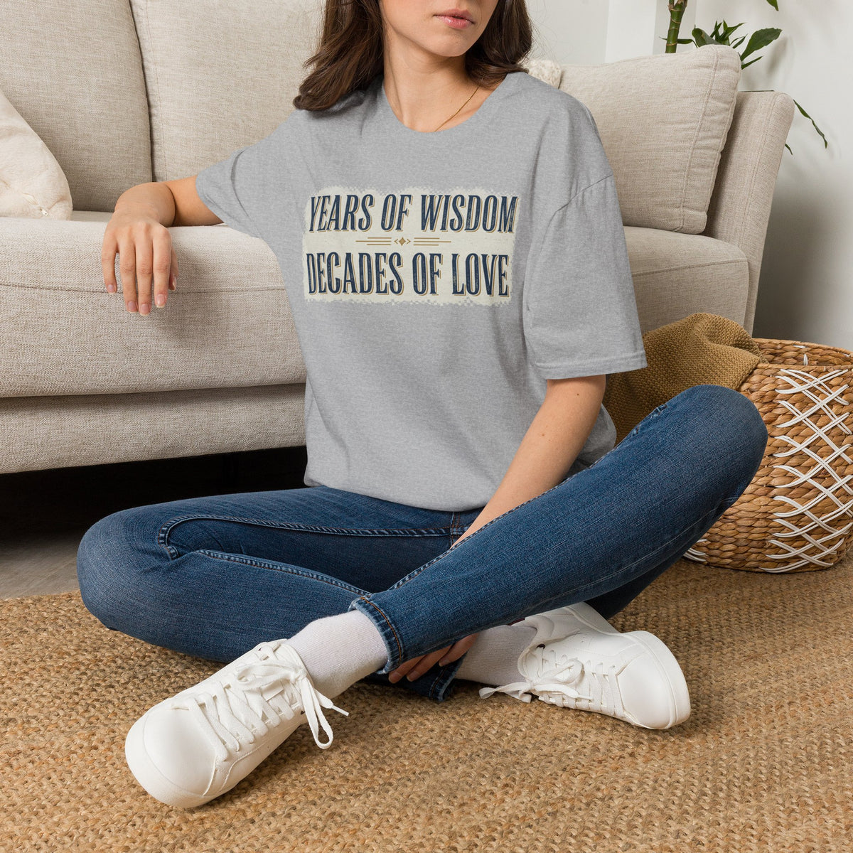 Gray crew-neck T-shirt with two-line quote graphic: "Years of Wisdom" and "Decades of Love".