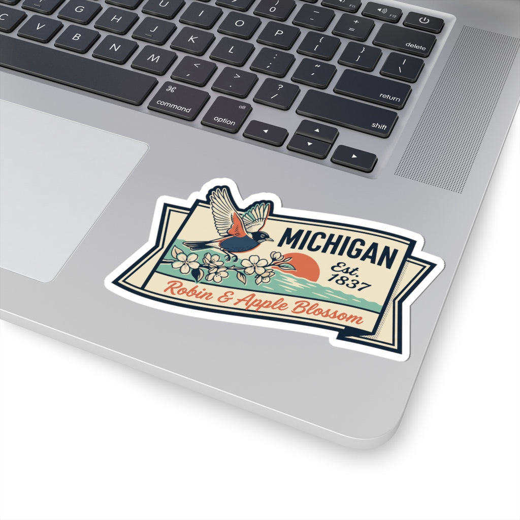 Michigan vintage sticker on laptop keyboard with robin, apple blossoms, and “Est. 1837”