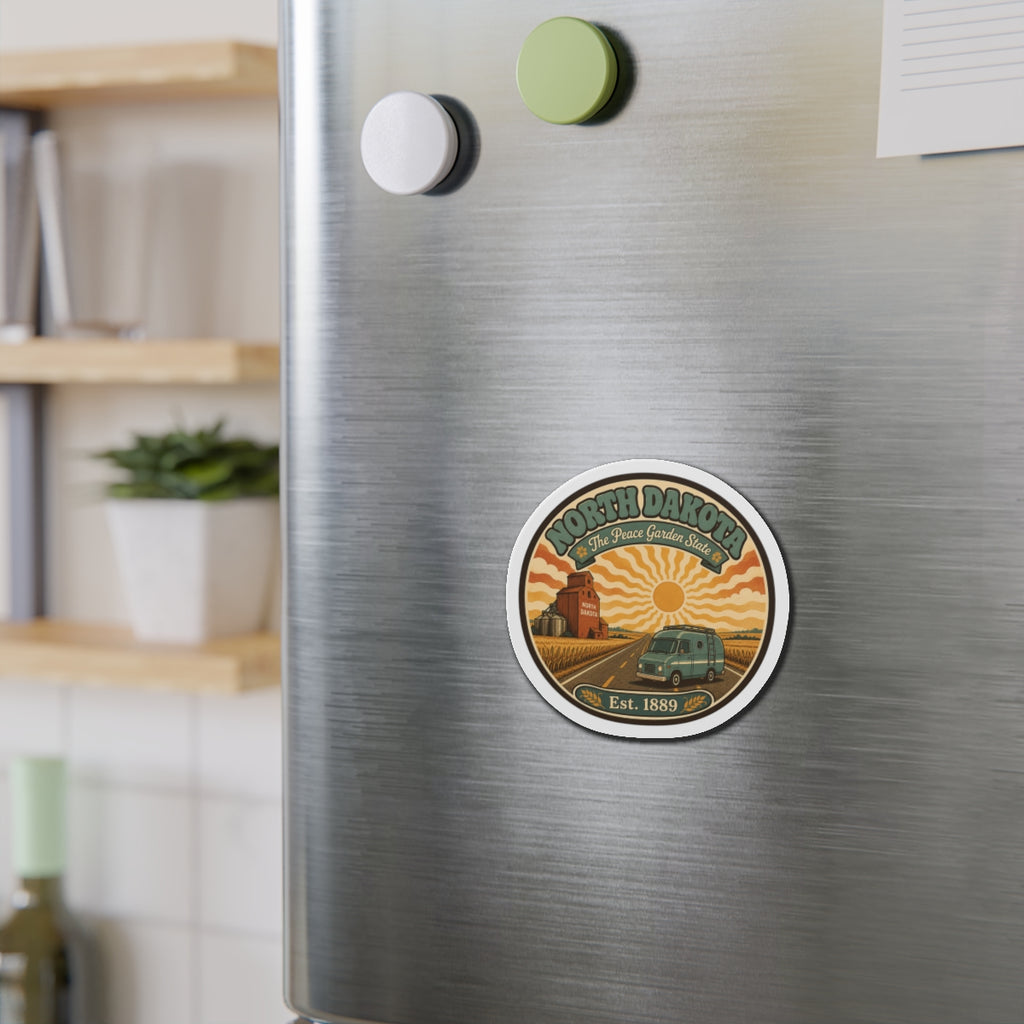 Round die-cut magnet on stainless refrigerator, North Dakota scene with Est. 1889