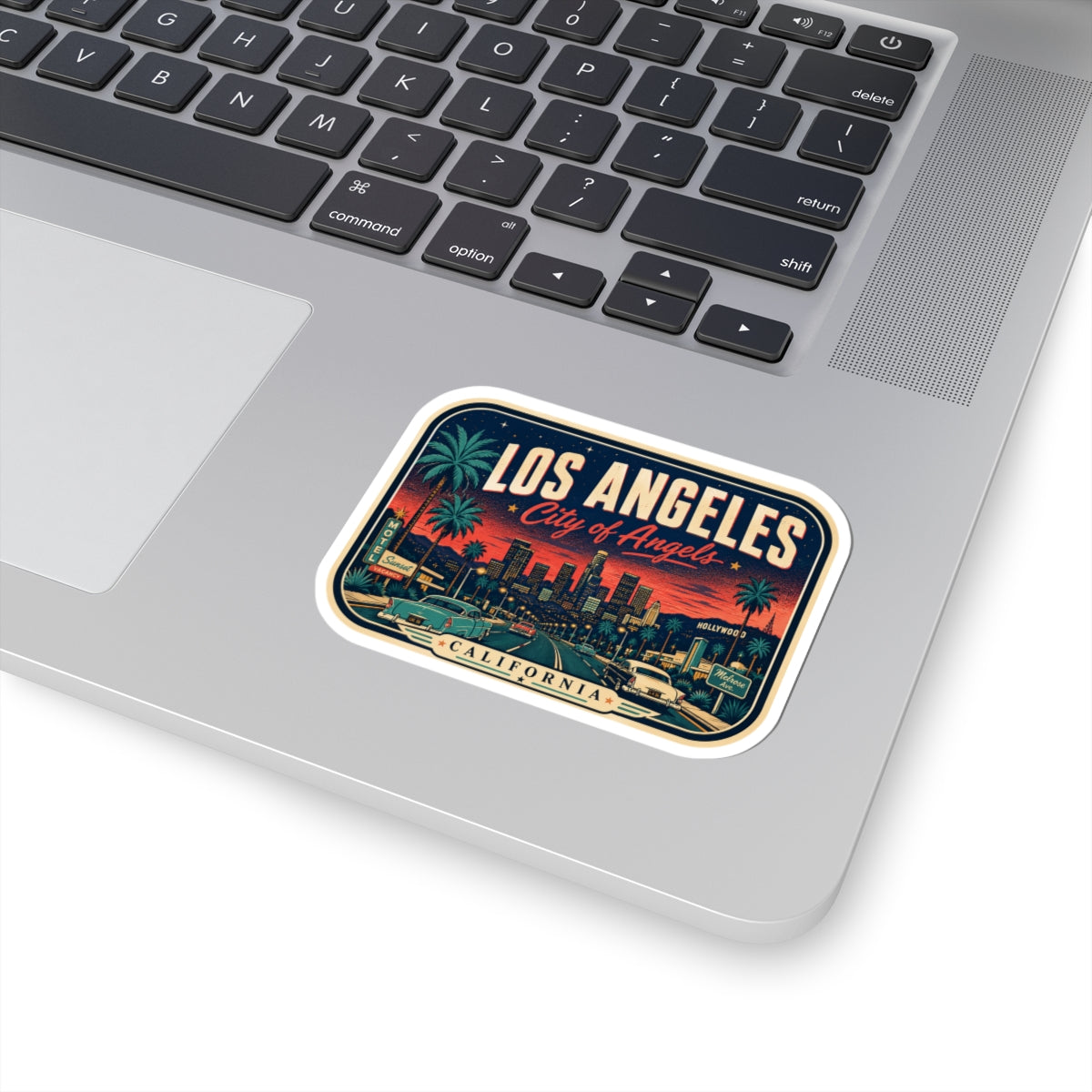 Luggage tag sticker on laptop lid with Los Angeles skyline and “City of Angels” text