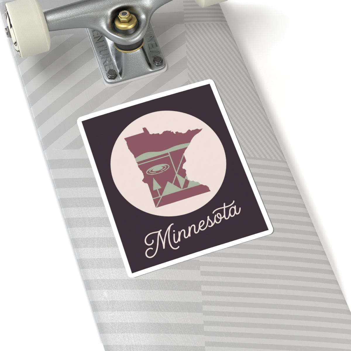Minnesota decal on skateboard deck, state silhouette circle with “Minnesota” script