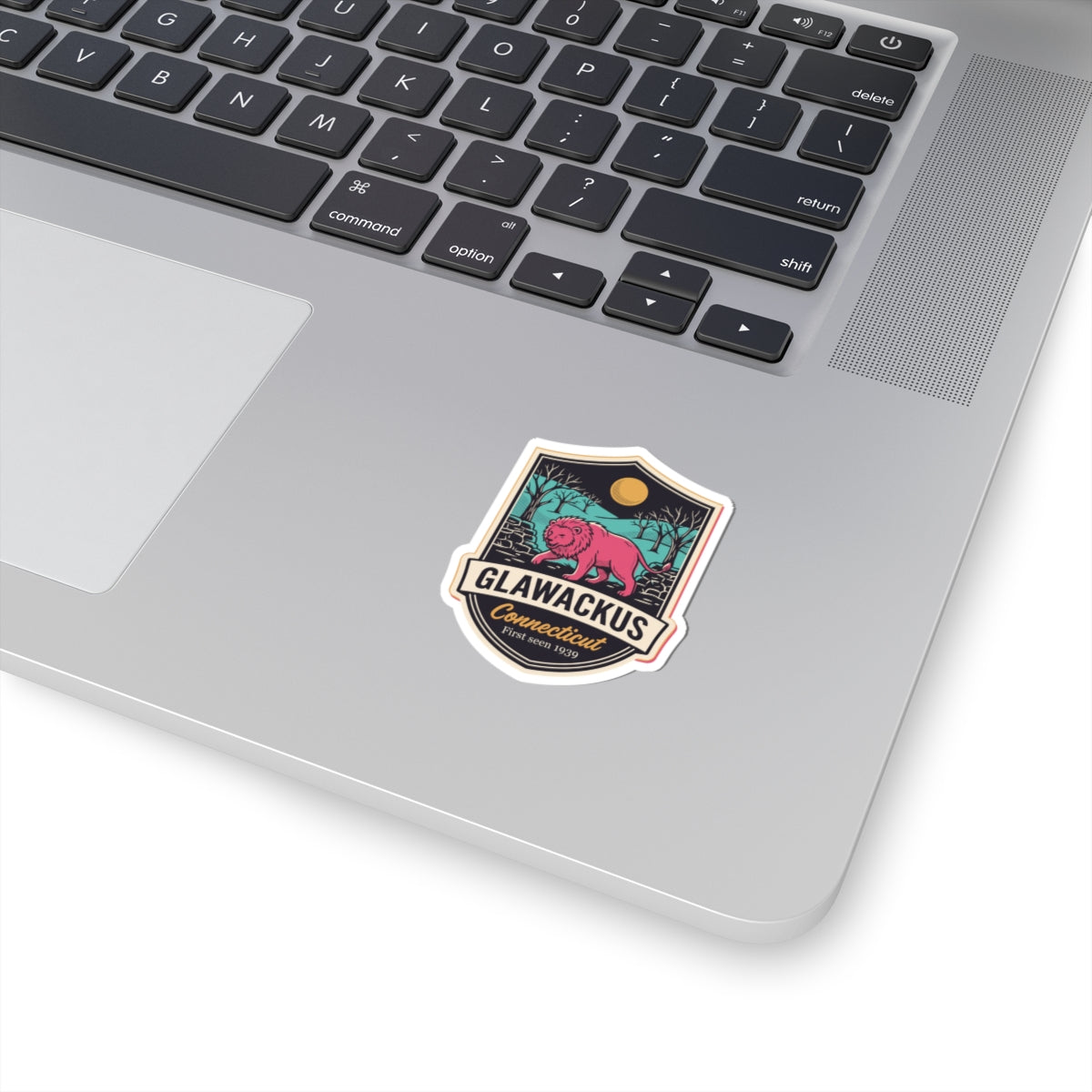 Kiss-cut vinyl decal sticker with colorful lion patch on laptop surface