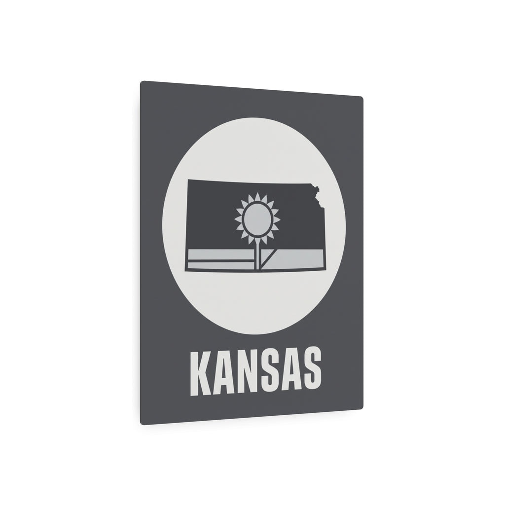 Dark gray metal Kansas wall sign with circular sunburst, Kansas outline, and 'KANSAS' text